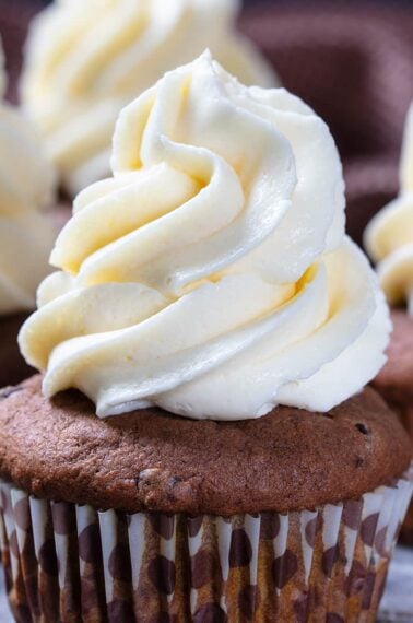close up buttercream frosting on a chocolate cupcake