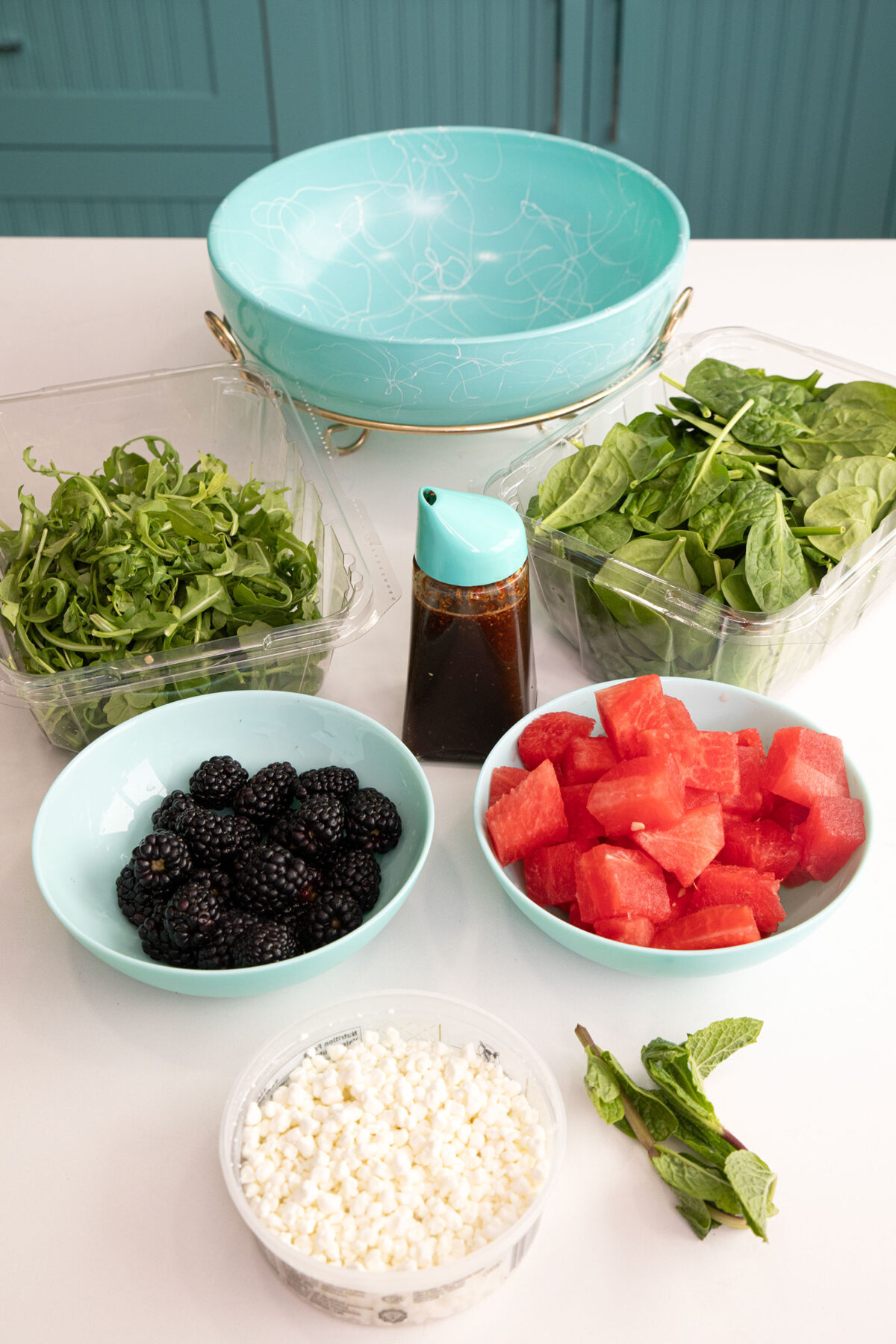 ingredients for the watermelon salad with feta and mint salad in small bowls