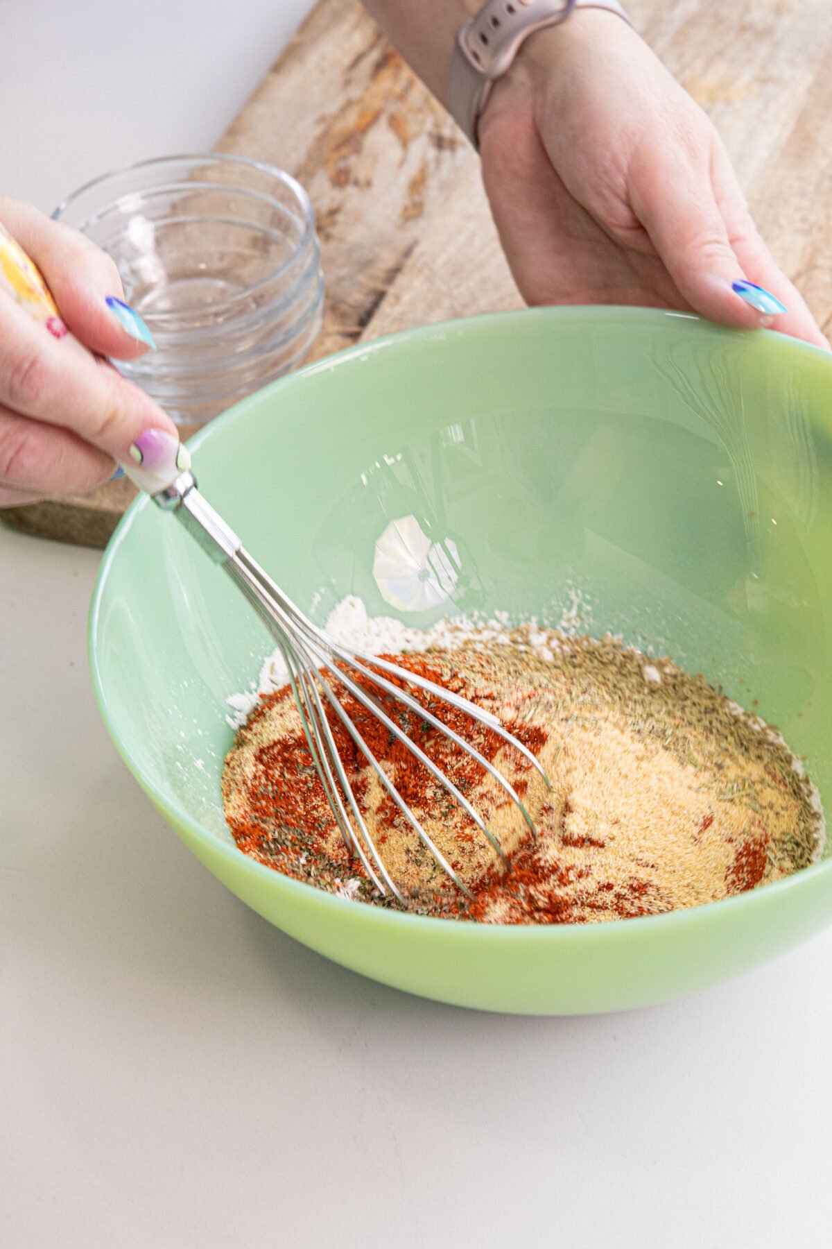 Make your own beef stew seasoning at home, instead of buying a package! You most likely have all of the spices in your cupboard at home.#thekitchenmagpie #easyrecipes #beefstew whisking spices for beef seasoning in a bowl